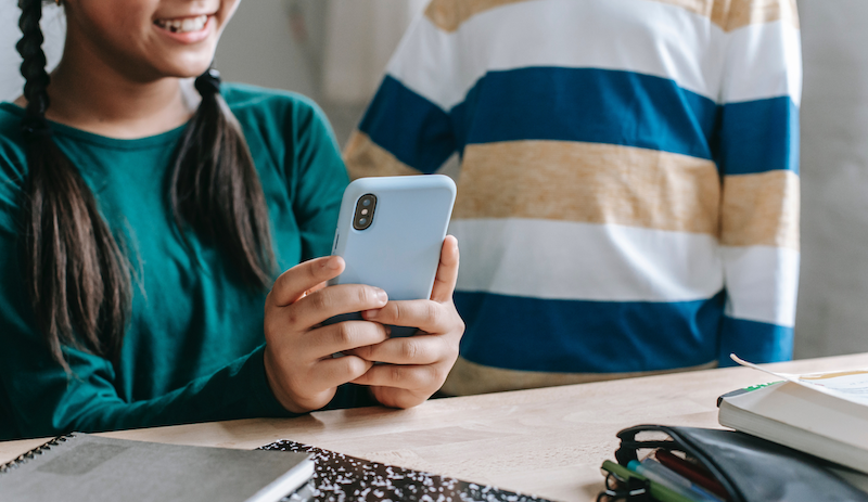 school privacy, girl smiling at phone