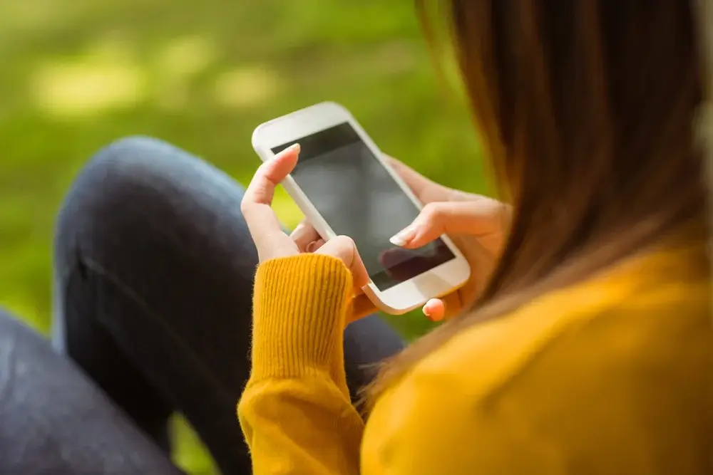 woman texting on cell phone