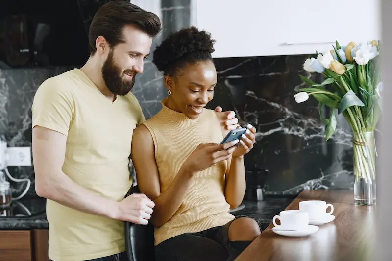 a couple wedding planning and texting and smiling 